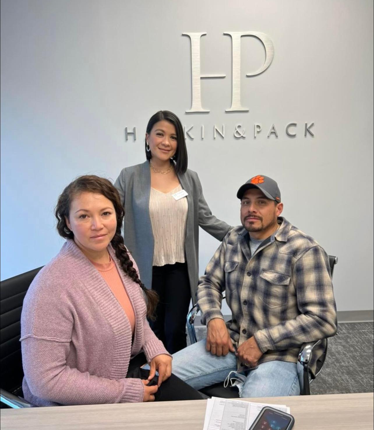 Sandy Alvear with clients at law office closing